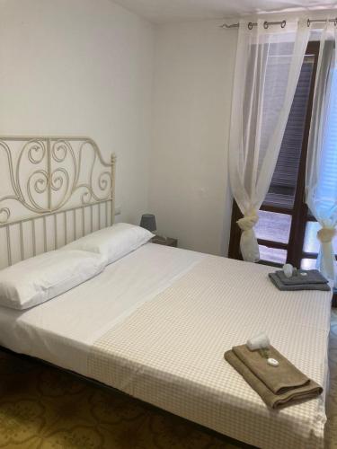 a bedroom with a bed with a towel on it at La stalla in Magione