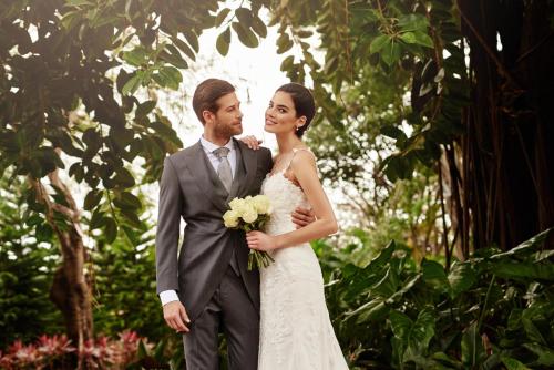 a bride and groom standing next to each other at El Embajador, a Royal Hideaway Hotel in Santo Domingo