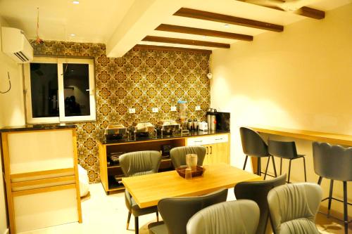 a dining room with a table and chairs in a kitchen at Oak Business Hotel in Hyderabad