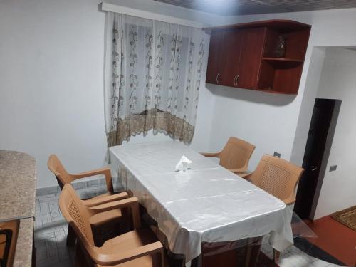 a dining room with a white table and chairs at Ilisu House in Qax