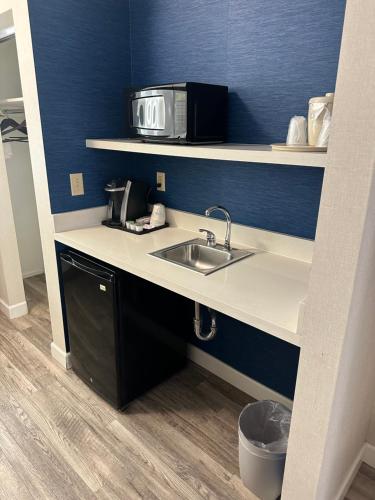 a kitchen with a sink and a microwave at Holiday Inn Express Hotel & Suites San Dimas by IHG in San Dimas