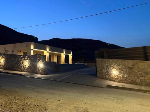 a house with lights on the side of a street at 180 Pool Villa in Anavissos