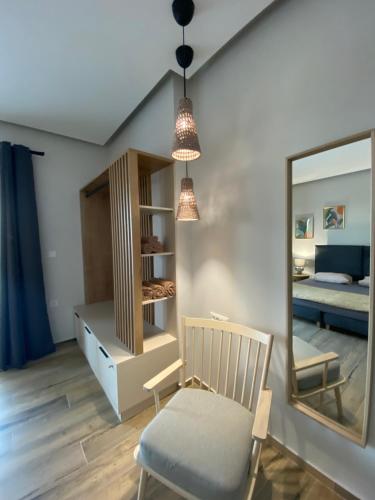 a room with a chair and a mirror and a bed at 180 Pool Villa in Anavissos