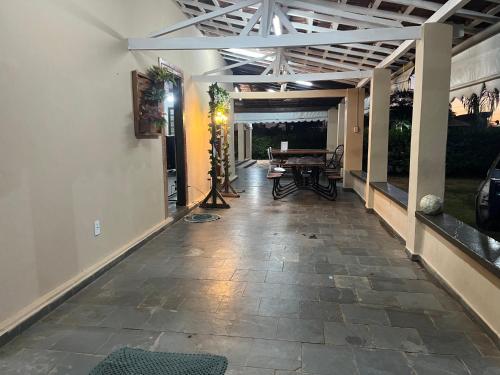 an empty hallway with a patio with a table at Chácara para Temporada Pai e Filhos in Sao Jose do Rio Preto
