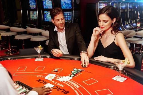 a man and a woman playing roulette in a casino at El Embajador, a Royal Hideaway Hotel in Santo Domingo