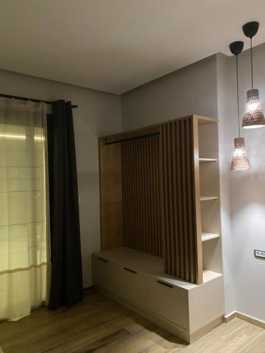 a room with a book shelf and two lights at 180 Pool Villa in Anavissos
