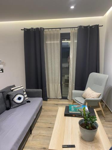 a living room with a couch and a chair at 180 Pool Villa in Anavissos