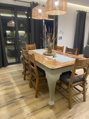 a dining room with a table and chairs at 180 Pool Villa in Anavissos