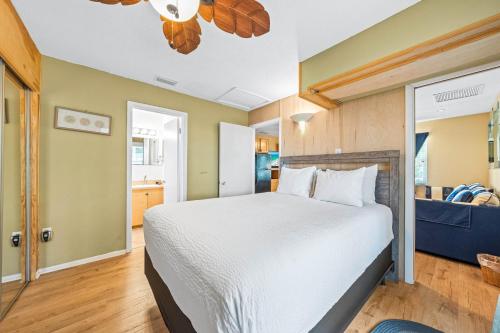 a bedroom with a large bed and a kitchen at Gulf Holiday By Beachside Management in Siesta Key