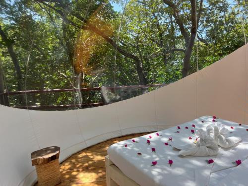 a room with a bed with flowers on it at Rock and Sea Resort in Watamu