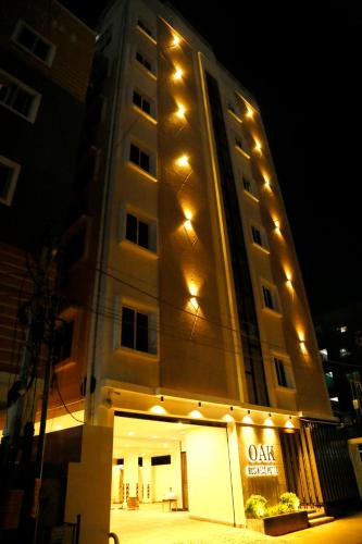 a tall building with lights on top of it at Oak Business Hotel in Hyderabad