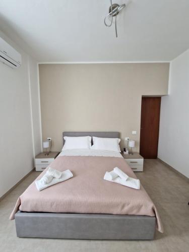 a bedroom with a large bed with two towels on it at B&B Noemi in Foligno