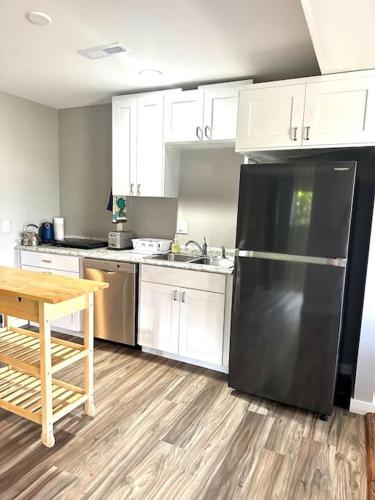 a kitchen with a black refrigerator and a table at Panoramic Views in Ashland