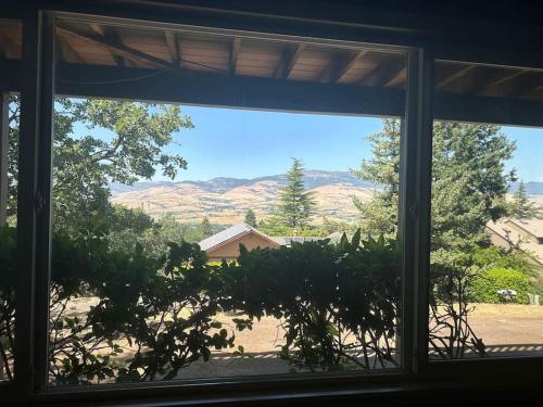 a window view of a mountain view from a house at Panoramic Views in Ashland