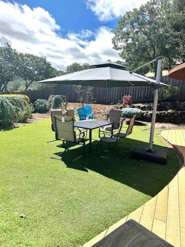 a table and chairs under an umbrella in a yard at Panoramic Views in Ashland