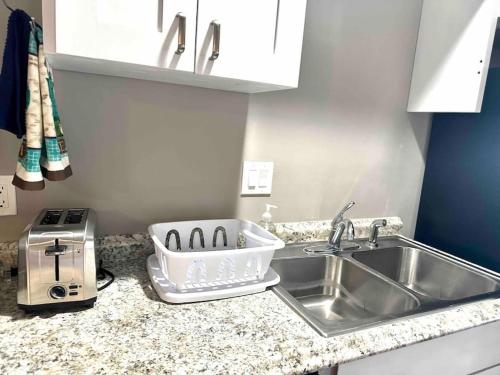 a kitchen counter with a sink and a toaster at Panoramic Views in Ashland
