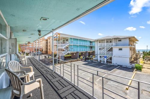 a balcony of a building with chairs and condos at Eden Roc Motel in Ocean City