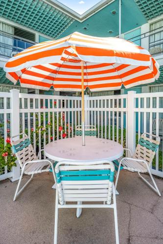 a table and two chairs with an umbrella at Eden Roc Motel in Ocean City