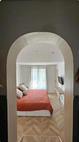 une chambre avec un grand lit avec une couverture rouge dans l'établissement Villa avec piscine privée, à Cadenet