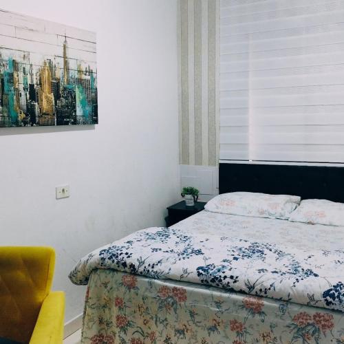 a bedroom with a bed and a painting on the wall at AEROHOSTEL Brasil in Guarulhos