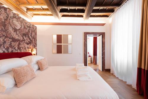 a bedroom with a large white bed in a room at My Trevi Suite & Apartment in Rome