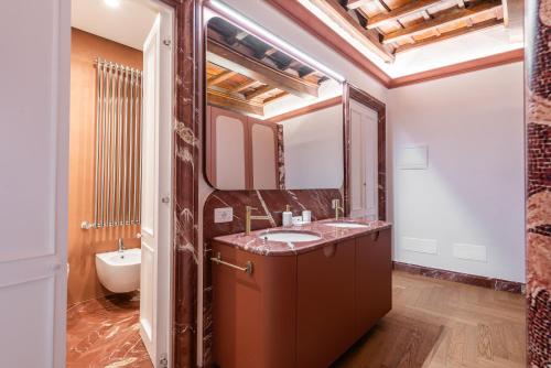 a bathroom with a sink and a mirror at My Trevi Suite & Apartment in Rome