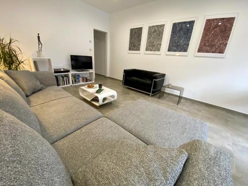 a living room with a couch and a table at ART HOUSE - Maison d'art in Mons