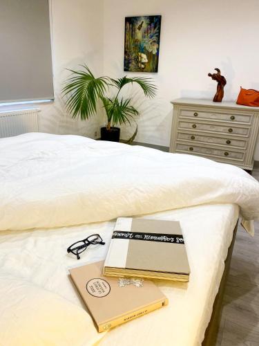 a bed with a laptop and a book on it at ART HOUSE - Maison d'art in Mons
