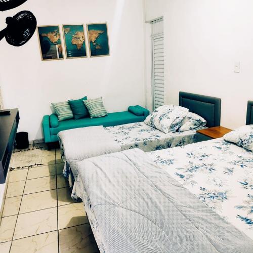 a living room with two beds and a couch at AEROHOSTEL Brasil in Guarulhos