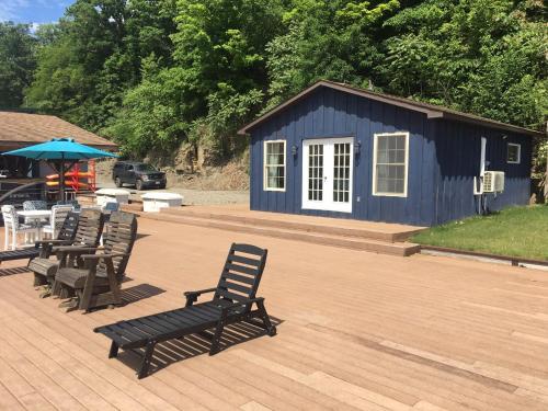 a group of chairs and a blue building with a table at The Dockaholic in Hammondsport