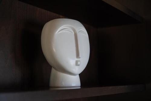 a white urinal on a shelf in a bathroom at Luxury Beach Villa in Skála