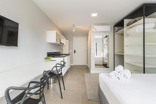 a kitchen and a living room with a table and chairs at GO 24 by My Way in Porto Alegre