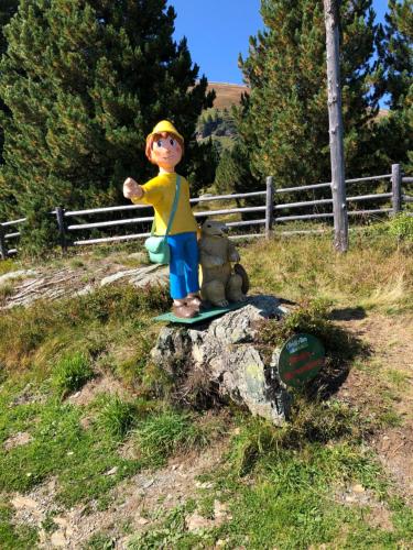 a statue of a boy standing on a rock with two teddy bears at Apartment RELAX Bad Kleinkirchheim in Wiedweg
