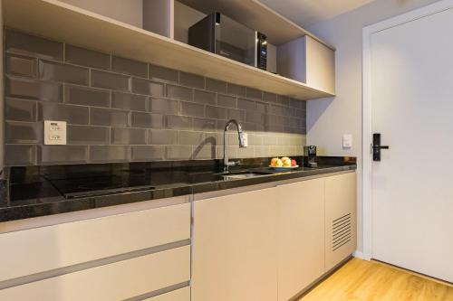 a kitchen with a sink and a counter top at GO 24 by My Way in Porto Alegre