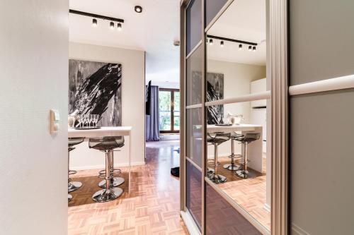 a home bar with stools in the hallway of a house at Ellivuori Asuinhuoneistot Apartments in Sastamala