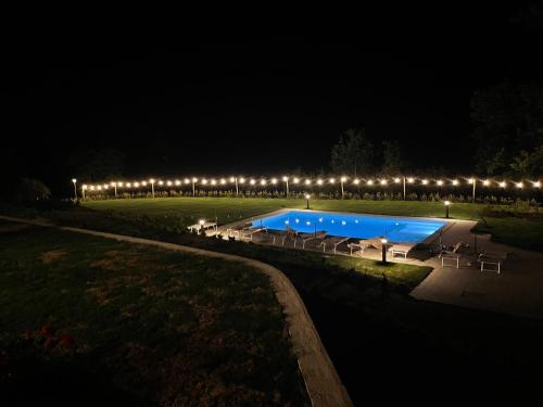 a swimming pool at night with a lot of lights at Agriturismo Villa San Marco in Montefelcino
