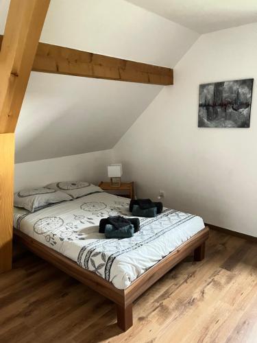 a bedroom with a bed with two bags on it at Ancienne ferme de Charles in Liebsdorf