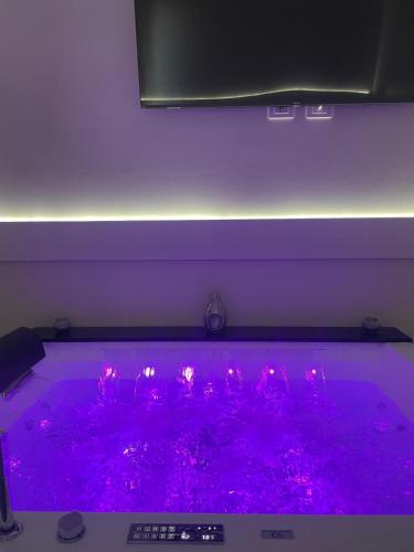 a hot tub with pink lights in a room at Le Cisterne Guest house Suite&Rooms in Vasto