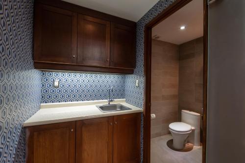 a small bathroom with a sink and a toilet at 1850 Hotel Boutique in Guanajuato