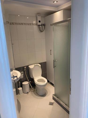 a bathroom with a toilet and a sink at Azure View Saranda in Sarandë