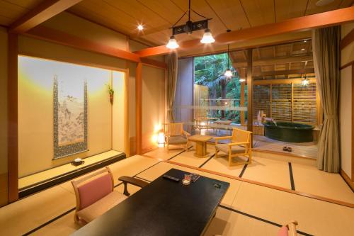 a room with a table and chairs and a window at Iwakuni Kokusai Kanko Hotel in Iwakuni
