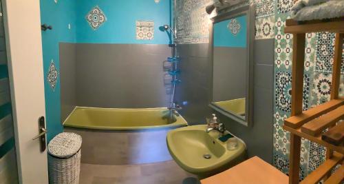 a bathroom with a tub and a sink at Gîte de la Ressourcery in Sainte-Marie-du-Mont