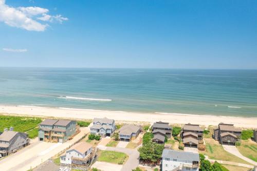 an aerial view of a beach with houses and the ocean at Duckin' Out in Sanderling