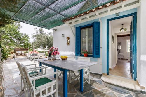 an outdoor patio with a table and chairs at Skopelos Sunset traditional country house in Panormos Skopelos