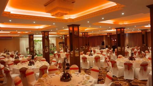 a large banquet hall with white tables and chairs at Laya Beach in Wadduwa