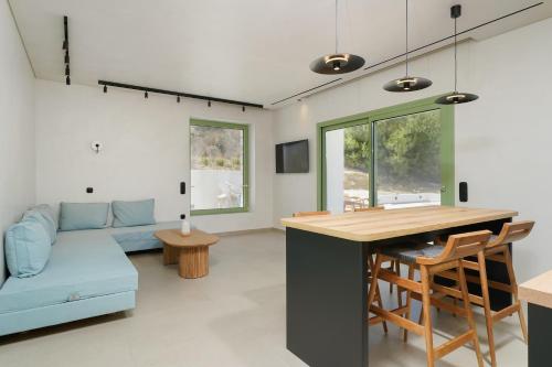 a kitchen and living room with a blue couch at NOMAS VILLAS With Private Pool in Potos