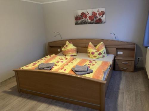 a bedroom with a bed with two pillows on it at Ferienwohnung Flecken Zechlin in Flecken Zechlin