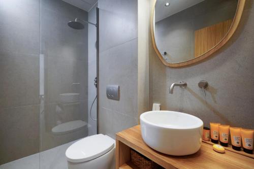 a bathroom with a toilet and a sink and a mirror at NOMAS VILLAS With Private Pool in Potos