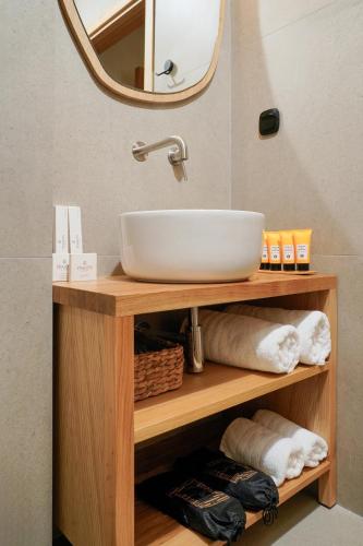 a bathroom vanity with a sink and a mirror at NOMAS VILLAS With Private Pool in Potos
