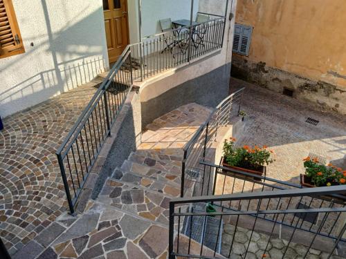 a set of stairs leading up to a building with flowers at App. Valentina in Segonzano